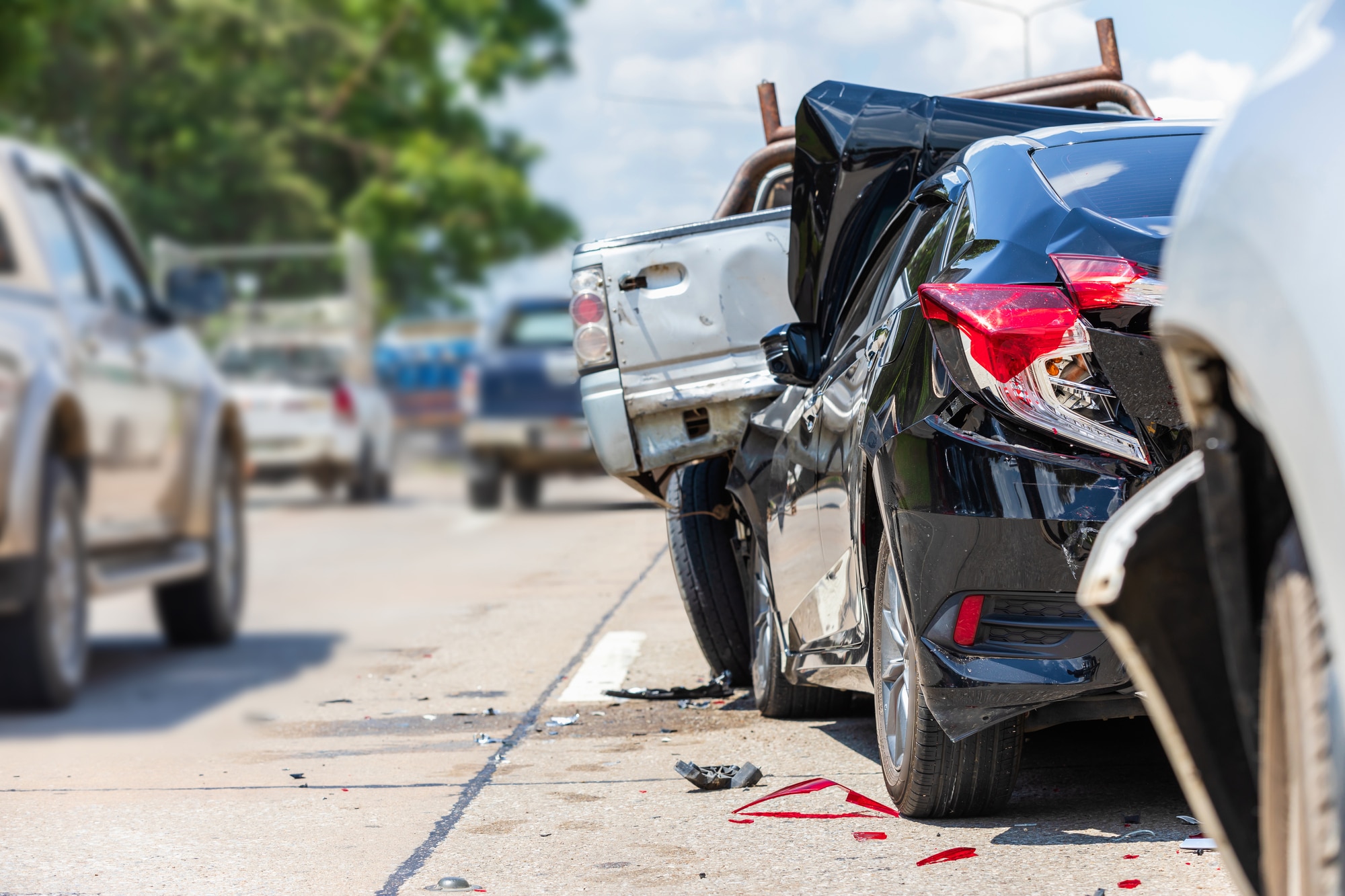 Damaged vehicles on the road after a fatal car accident