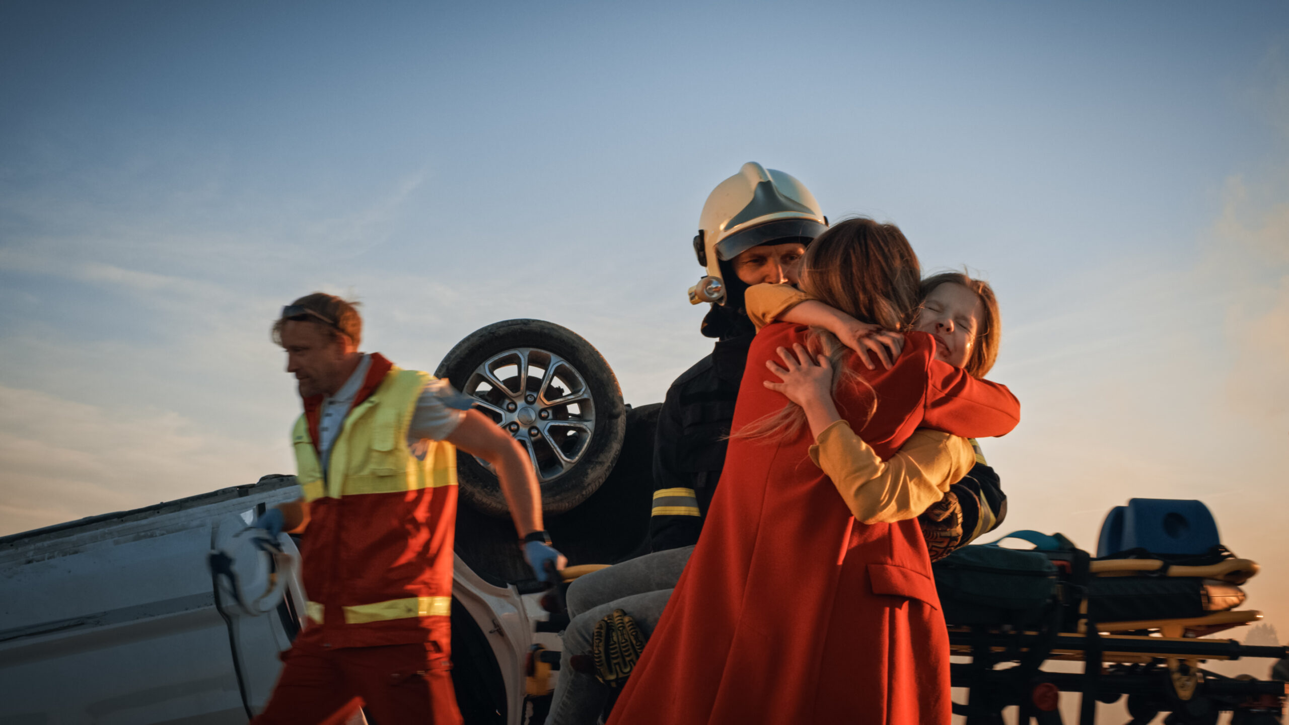 Mother and daughter hugging after being rescued from a car accident